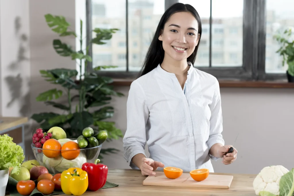 Woman beside a kitchen counter with fresh produce